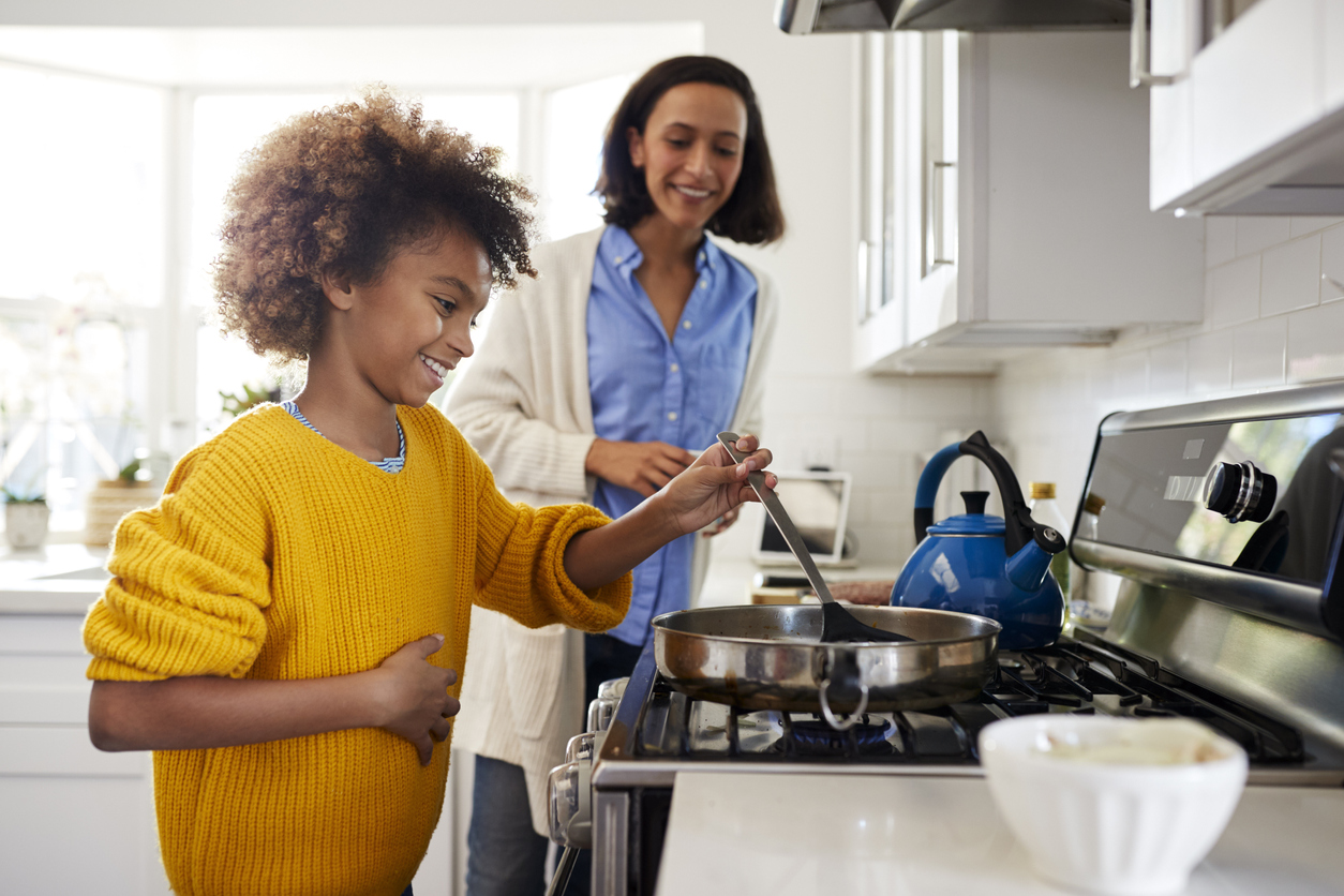 Mother and daughter cooking together in kitchen