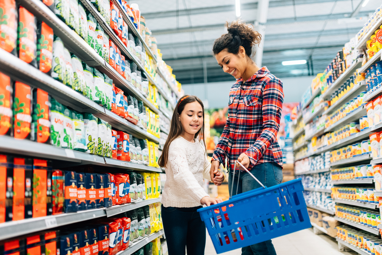 Mother and daughter grocery shopping in store